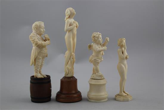 A late 19th century German carved ivory figure standing on a barrel, largest 6.5in. incl. wood plinth